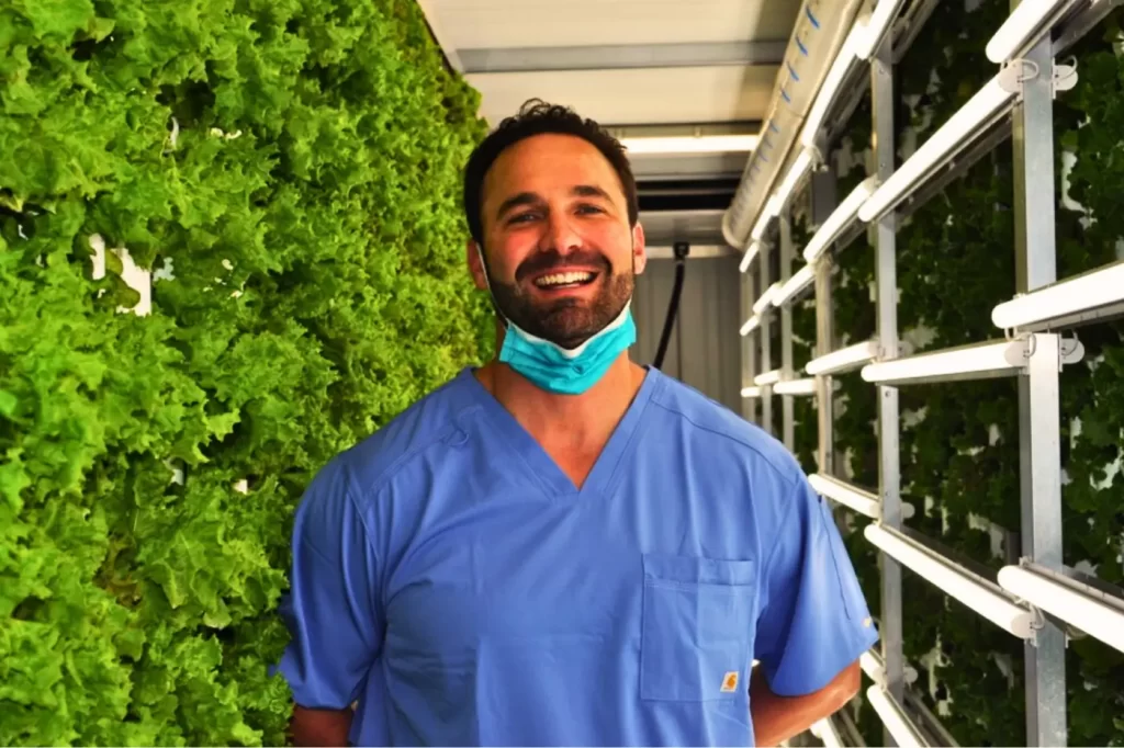 Photo of Beau Gertz in a shipping container farm.