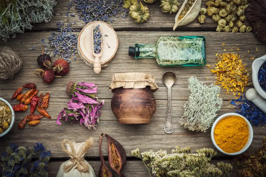 Colorful herbs and spices from an urban garden being ground up and processed on a wooden table